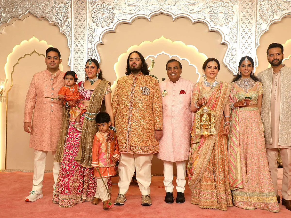 The entire Ambani family seen in pastel colours. From left to right: Akash Ambani with with wife Shloka and children, Anant Ambani, Mukesh Ambani, Nita Ambani, Isha Ambani with husband Anand Piramal