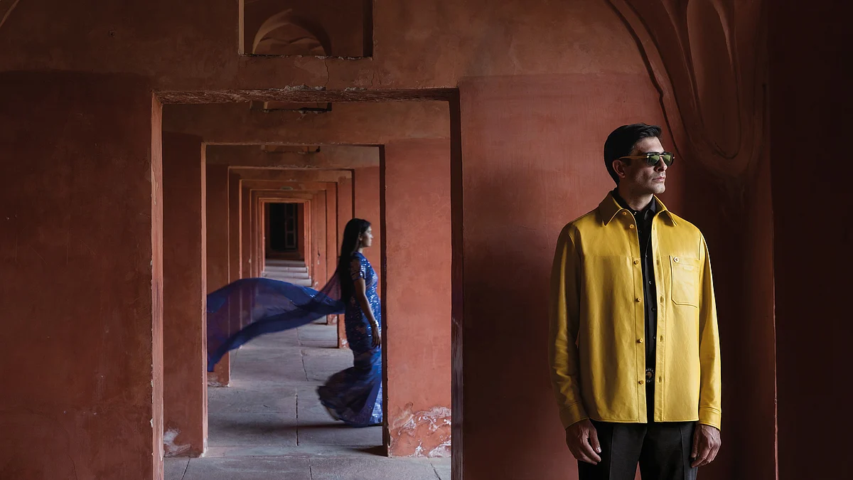 The ensemble consists of an overshirt, made from 100% Nappa lambskin leather, a casual shirt made of cotton and silk—along with sports trousers made out of 100% virgin wool, a pair of prestige sunglasses, and a handmade belt made of 100% matted crocodile with sneakers made of suede, and calfskin leather