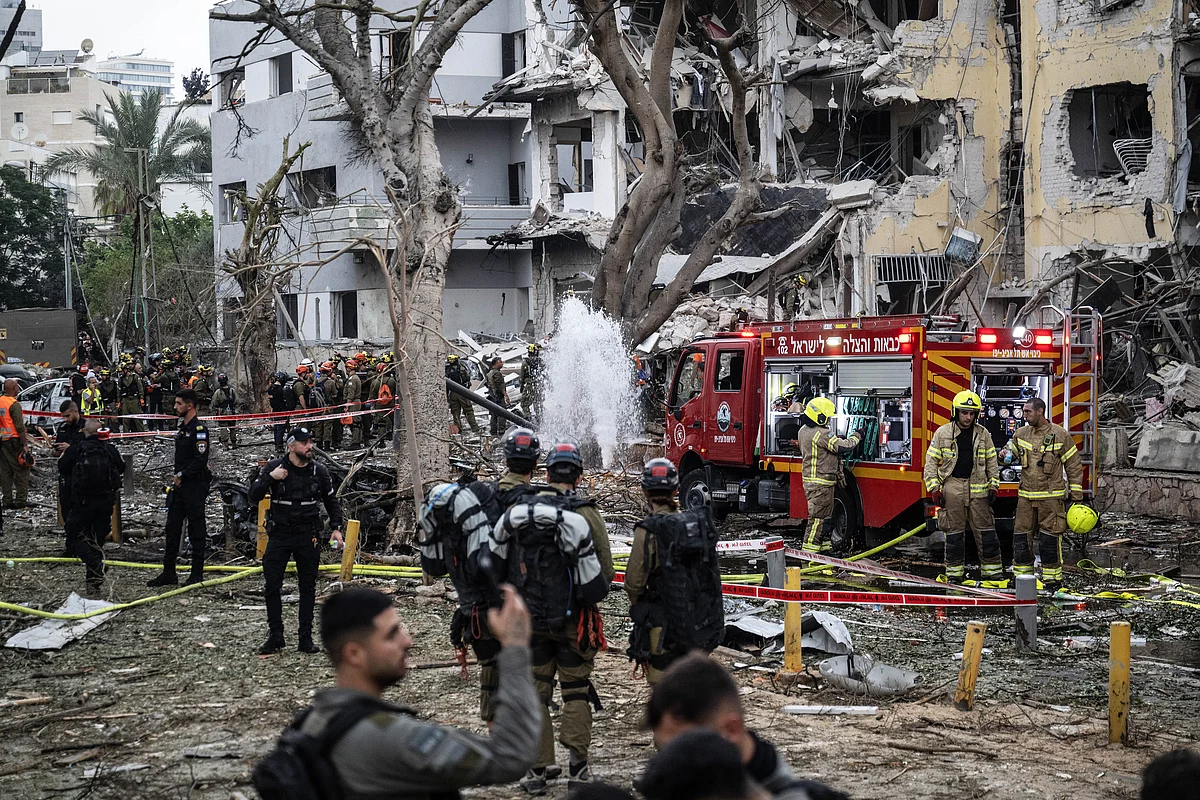 Israeli civil defense and fire brigades continue search and rescue operations after Iranian strikes damage buildings in Tel Aviv, Israel. 