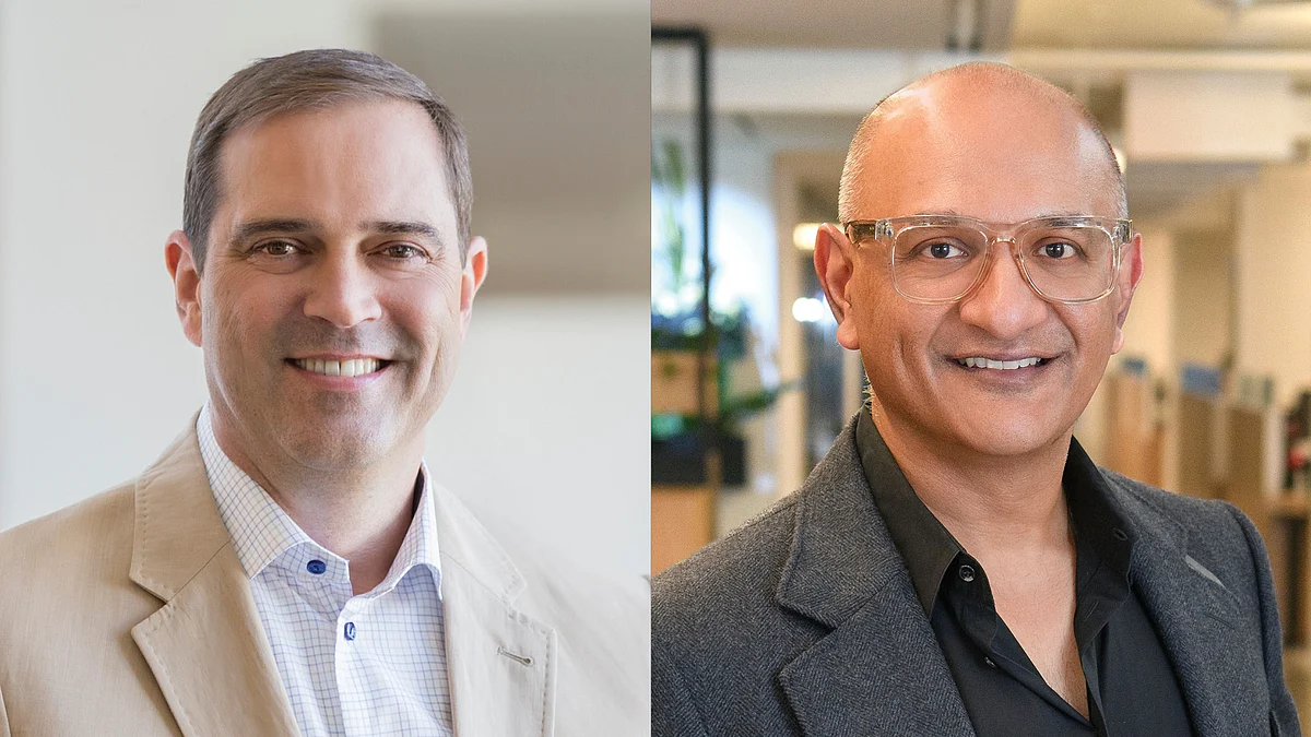 Cisco Systems, led by CEO Chuck Robbins and Jeetu Patel (right), is reinventing itself as an AI-first company.