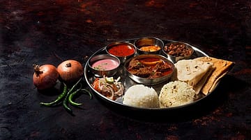 Home-cooked veg thali cost rises 5%, non-veg thali up 7% in May on higher tomato, LPG prices: Crisil