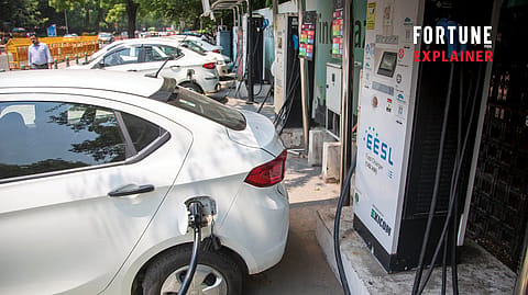 An electric vehicle being charged at a public charging station. The government’s EV manufacturing policy aims to attract global automakers and boost local EV production.