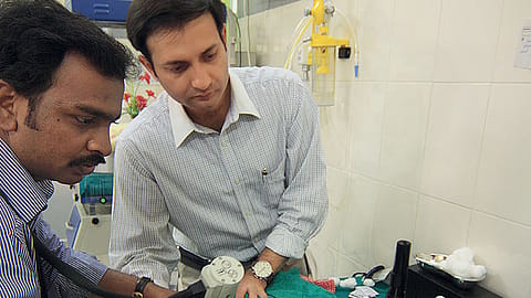 Dr. Anand Vinekar (right) at the imaging of a baby’s retina.