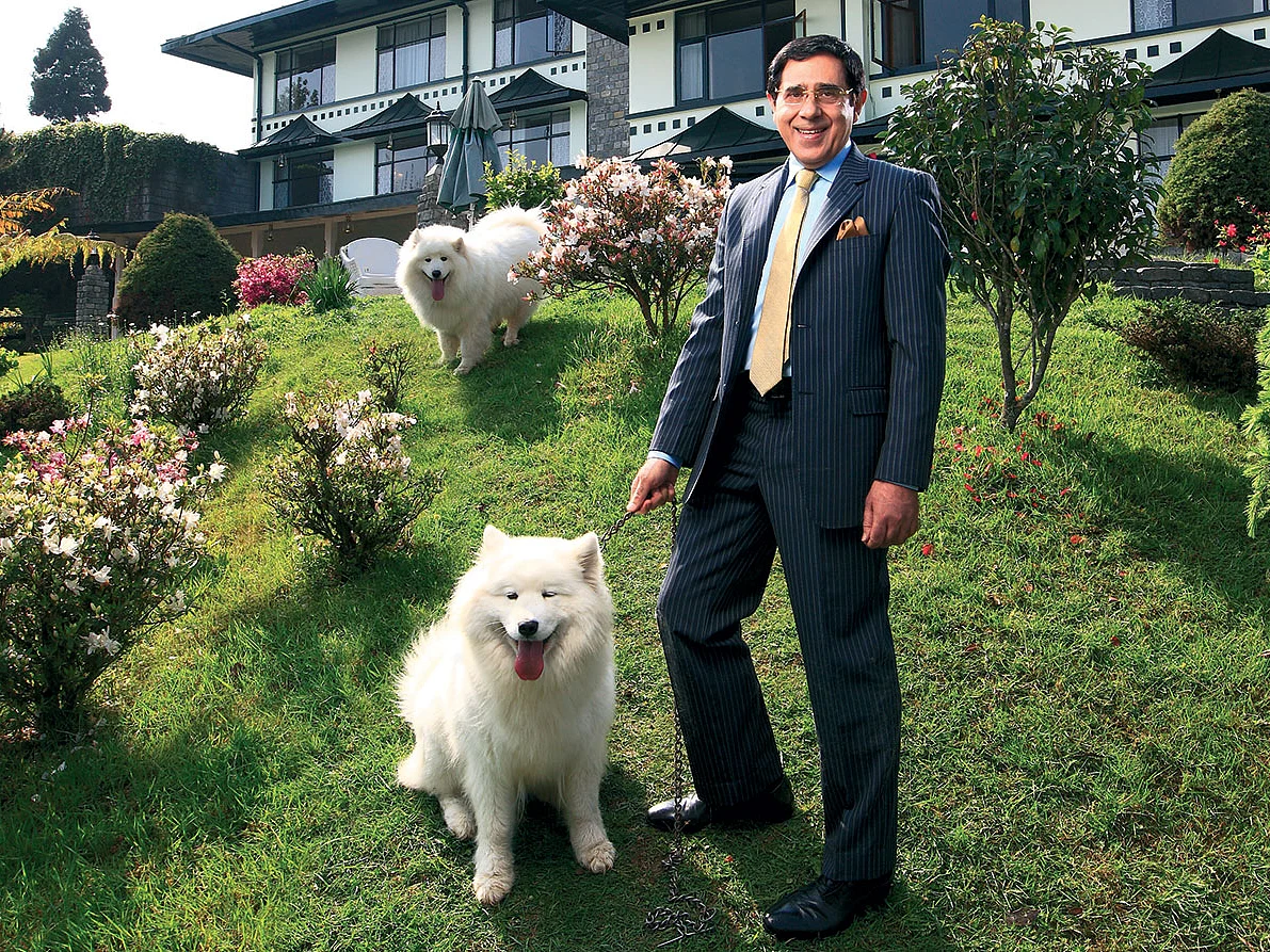 Brij Raj Oberoi, founder and managing director of the Elgin Group, with his pets Mickey and Rosé (behind). 