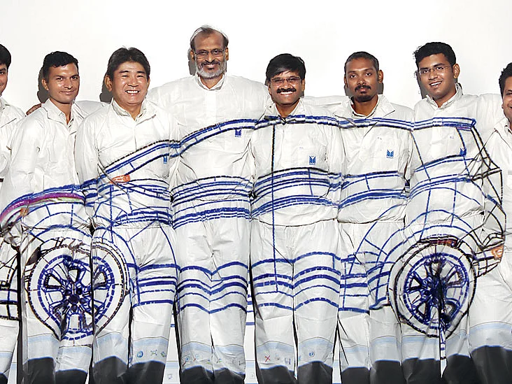 Research on motion: Maruti Suzuki’s R&D team, headed by I.V. Rao (centre), made history by developing the first all-Indian car. Here they pose with the wireframe image of the RLL projected across them.