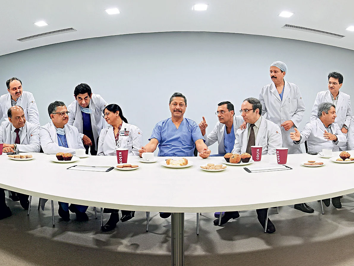DR. Naresh Trehan (in blue) is the pivot on which Medanta The Medicity revolves. He is seen here surrounded by the heads of the hospital’s departments.