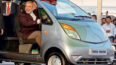 Gujarat chief minister Narendra Modi tests a Tata Nano