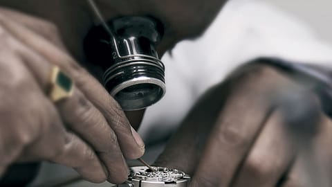 A technician examines the complex innards of a watch at the Mumbai Rolex service centre.
