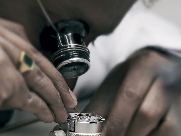 A technician examines the complex innards of a watch at the Mumbai Rolex service centre.