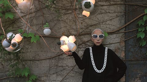 Rossana Orlandi portrayed in her courtyard with lamp n.38 by Omer Arbel for Bocci.
