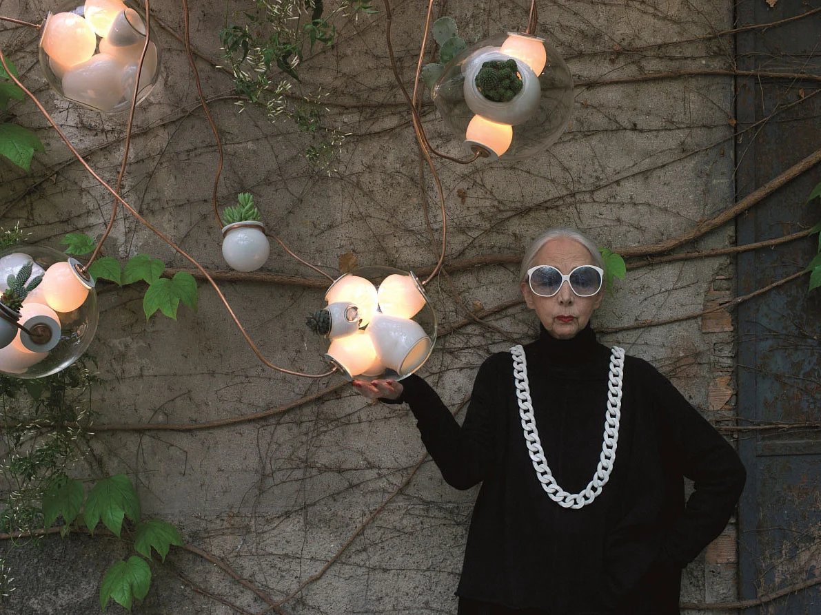 Rossana Orlandi portrayed in her courtyard with lamp n.38 by Omer Arbel for Bocci.