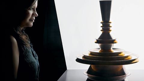 Gunjan Gupta photographed with Eatstack—a sculptural stack of vessels that deconstructs to create a thaali set suited for Western or Indian dining. The design has been inspired by Indian architectural
forms.