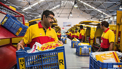 Lead courier Stanley Paul Fernandes (l) with his team at DHL Express India's sorting hub at Byculla, Mumbai