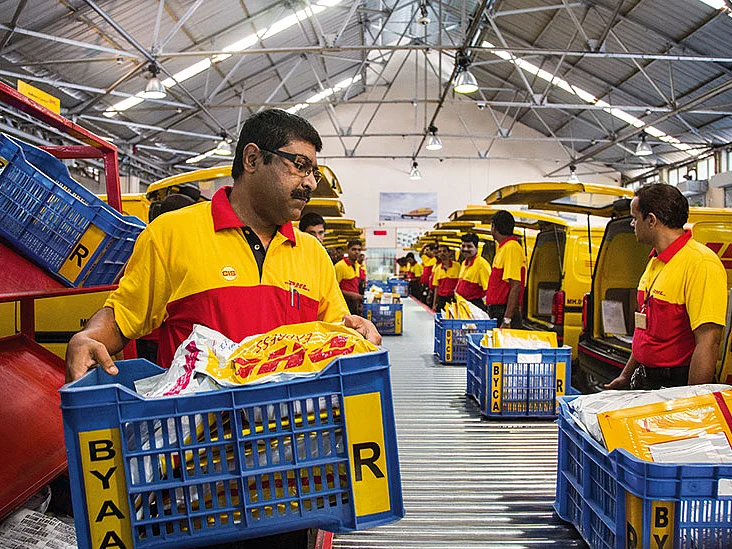 Lead courier Stanley Paul Fernandes (l) with his team at DHL Express India's sorting hub at Byculla, Mumbai