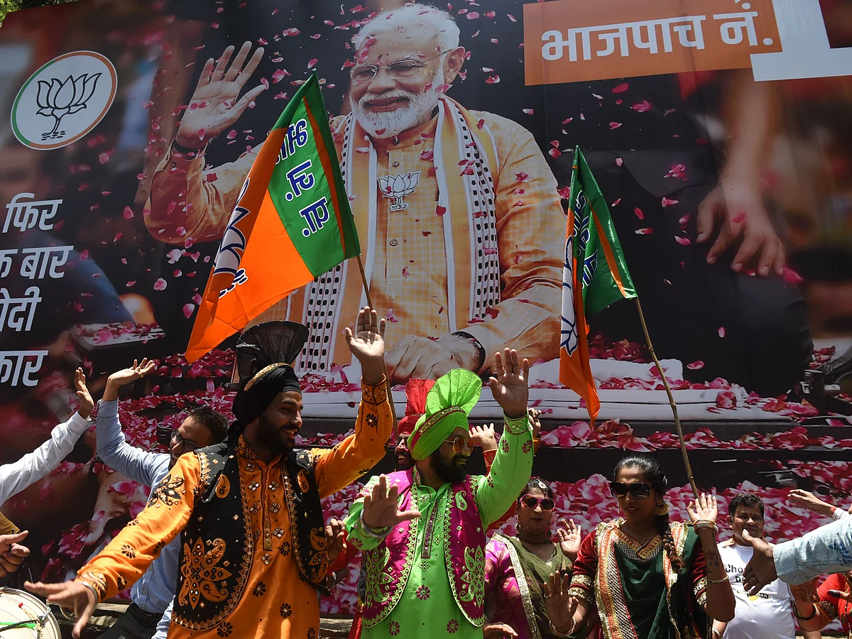 Supporters of Indian Prime Minister Narendra Modi and his ruling Bharatiya Janata Party (BJP) celebrate the election results outside the BJP headquarters in Mumbai on May 23, 2019