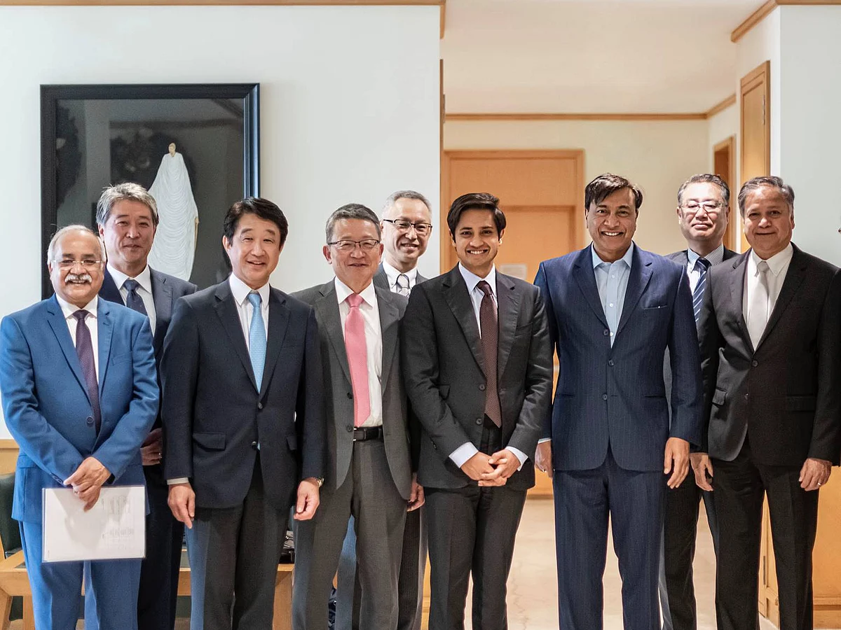 Lakshmi Mittal and Aditya Mittal with members of the ArcelorMittal and Nippon Steel teams following completion of the acquisition of Essar Steel.