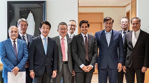 Lakshmi Mittal and Aditya Mittal with members of the ArcelorMittal and Nippon Steel teams following completion of the acquisition of Essar Steel.