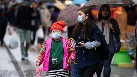 People wearing masks to protect themselves against the Novel Coronavirus, in North Point market, Hong Kong, China.