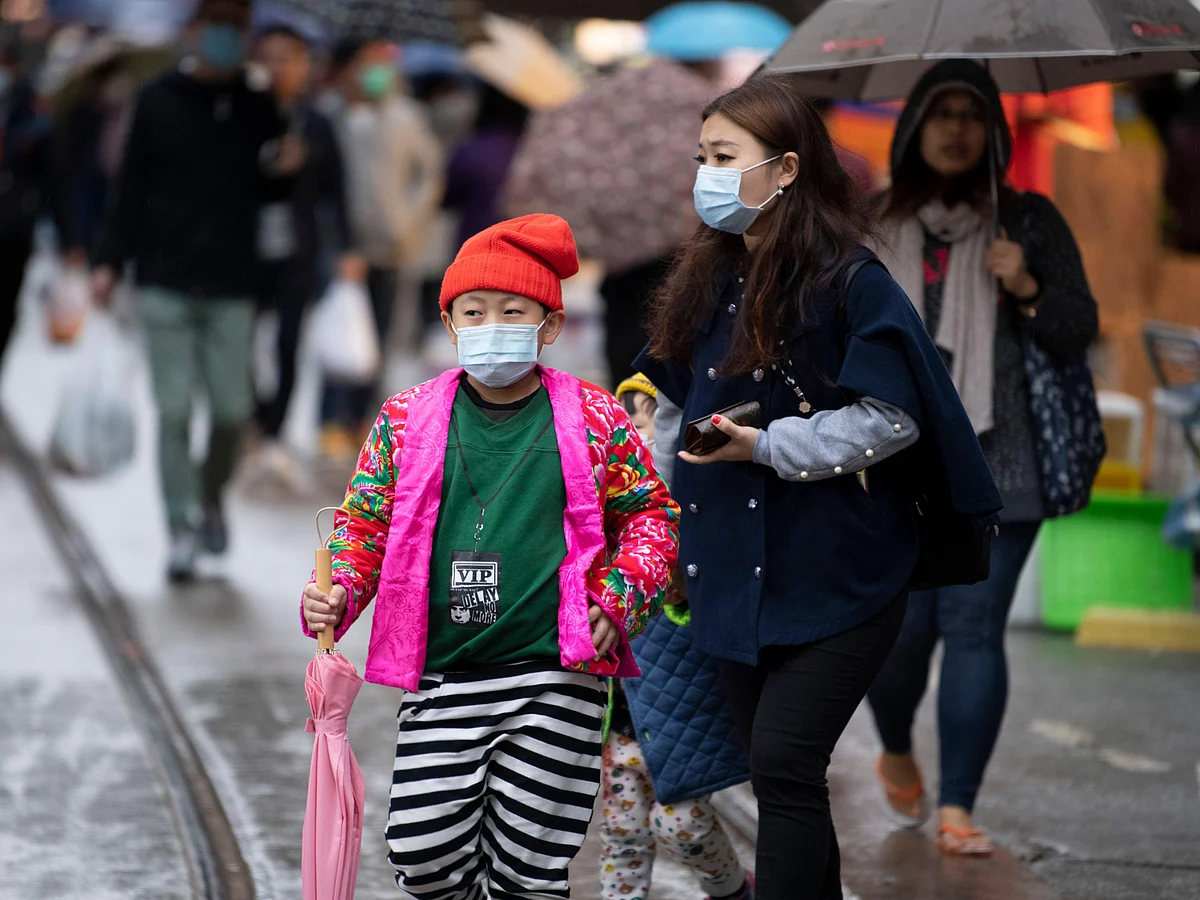 People wearing masks to protect themselves against the Novel Coronavirus, in North Point market, Hong Kong, China.