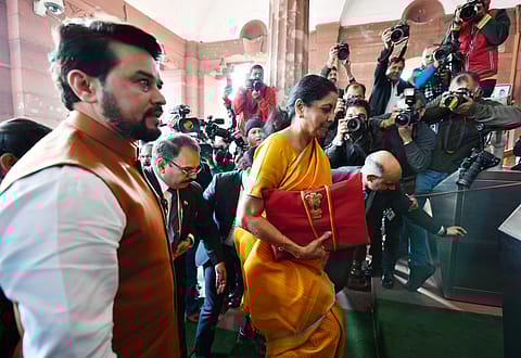 Finance minister Nirmala Sitharaman arrives at Parliament House to present the Budget, in New Delhi on Saturday. Minister of state for finance and corporate affairs Anurag Singh Thakur is also seen.