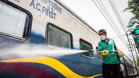 A worker disinfects a train.
