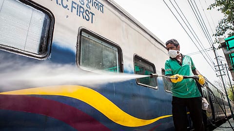 A worker disinfects a train.