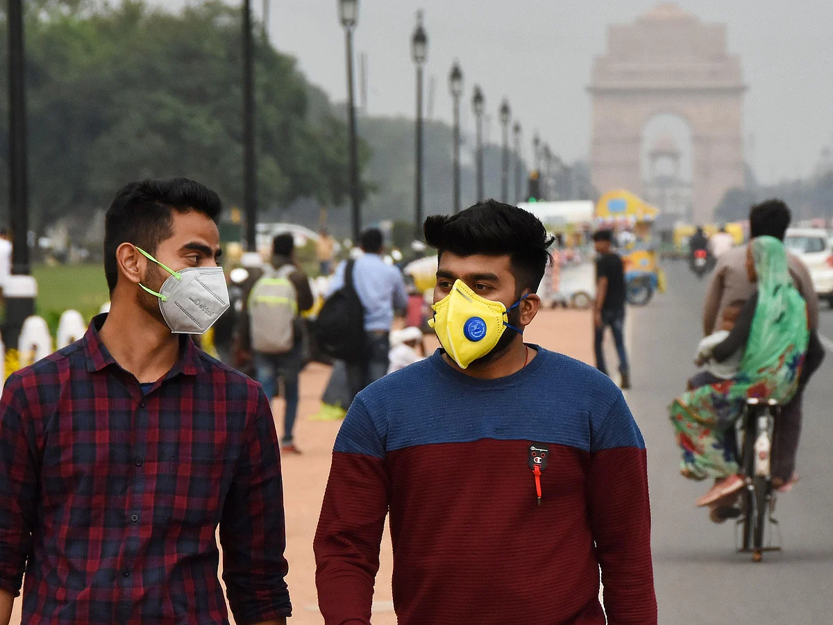 People wearing face masks on a Delhi road close to  India Gate as a preventive measure against the spread of the coronavirus outbreak.