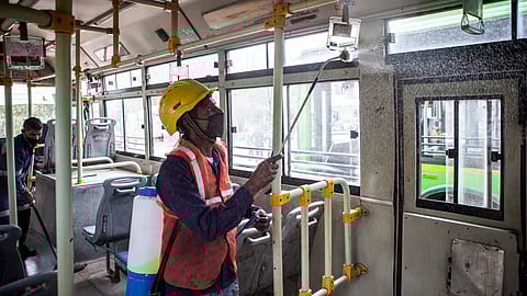 A worker disinfects a bus in New Delhi.