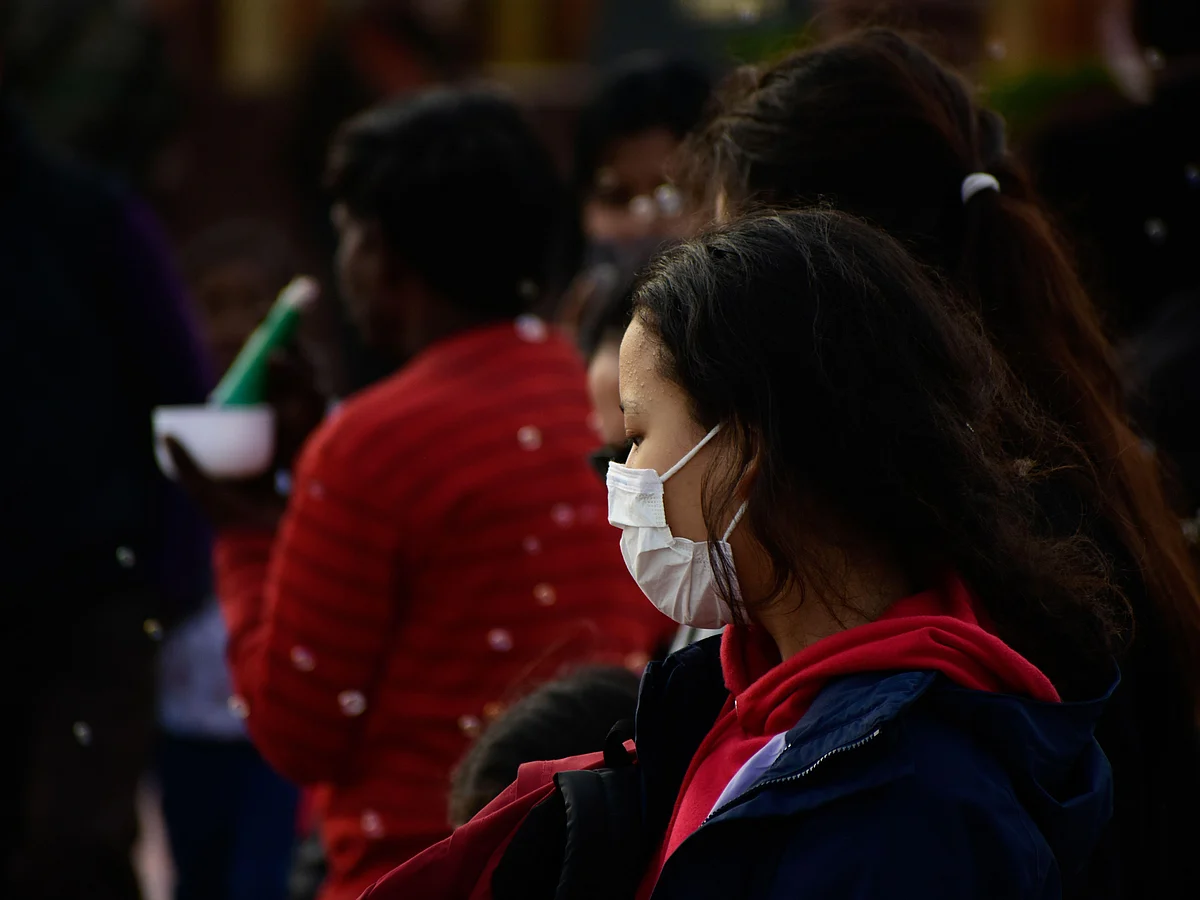  People in the street wear masks amid fears of spread of the novel coronavirus in New Delhi.