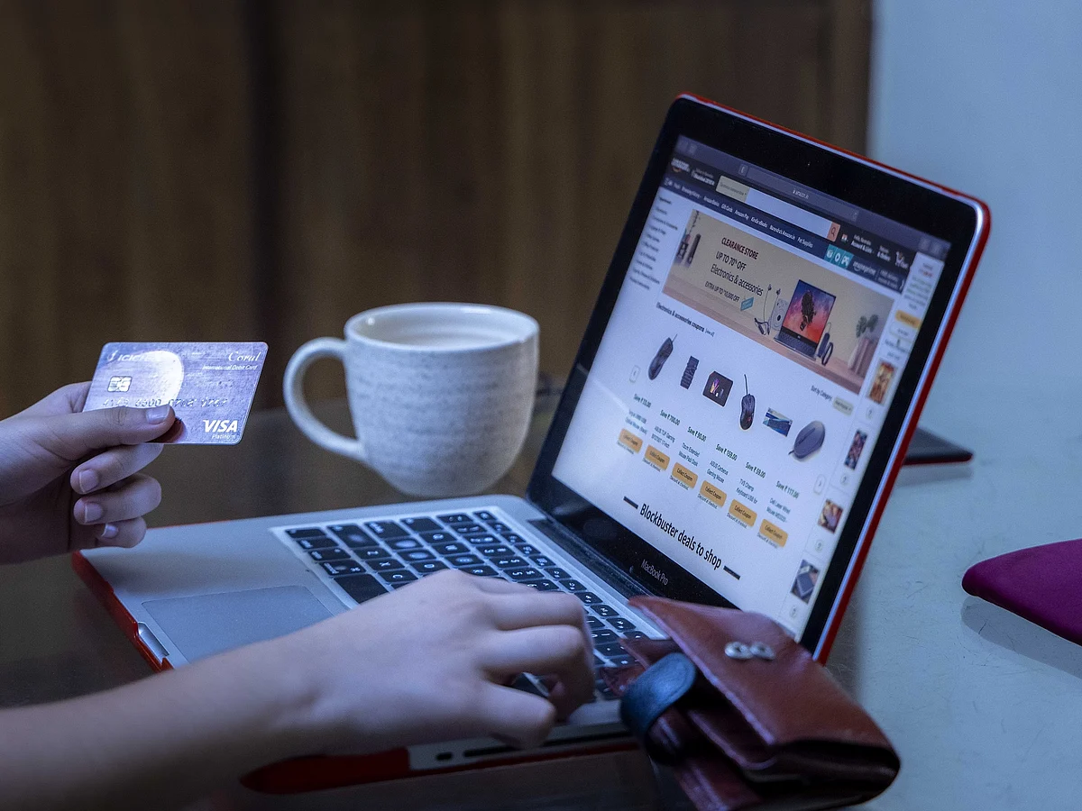 A representational image of a shopper using their card to shop for products on an e-commerce website.