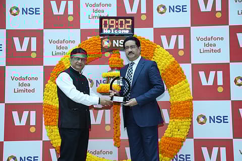 Aditya Birla Group chairman Kumar Mangalam Birla with Ashishkumar Chauhan, MD & CEO of NSE, (R-L) at listing ceremony of Vi FPO shares 