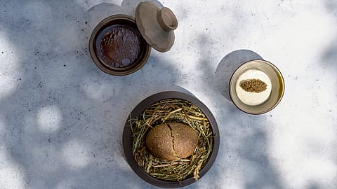 Potato cooked in a summer hay crust, cultured cream with caviar by Chef Ana Ros; corn beignet, fermented cottage cheese, smoked trout roe, wild chives.