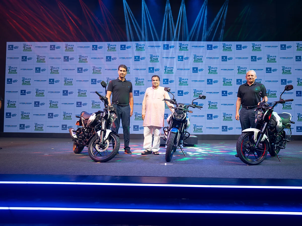 Bajaj Auto managing director Rajiv Bajaj (extreme left) with Union minister Nitin Gadkari (centre) at the launch of CNG motorcycle Freedom.