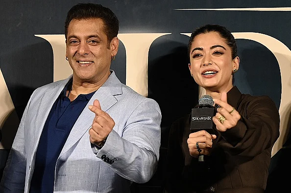 Bollywood actor Salman Khan with Rashmika Mandanna (R) at the trailer launch of Sikandar.